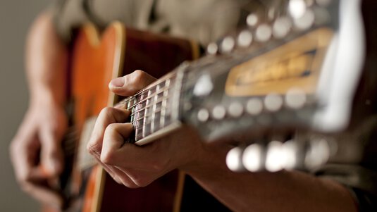 Someone playing guitar